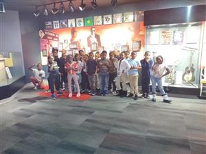 students standing in front of a musical exhibit
